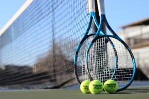 tennis net with rackets and balls at corpus christi athletic club